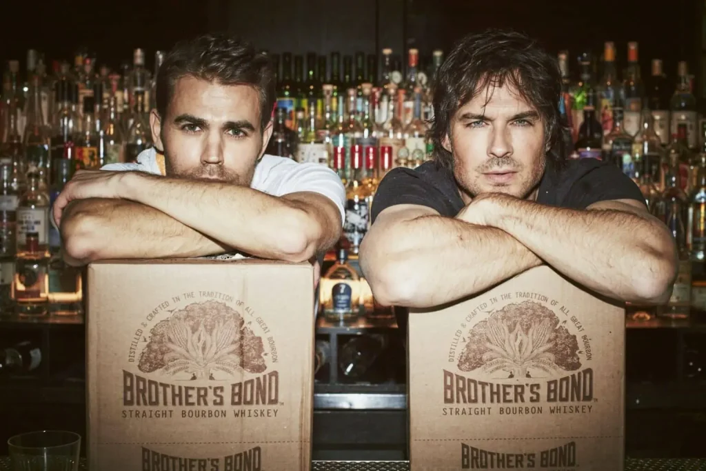 Ian Somerhalder and partner leaning over the back of Brother's Bond boxes