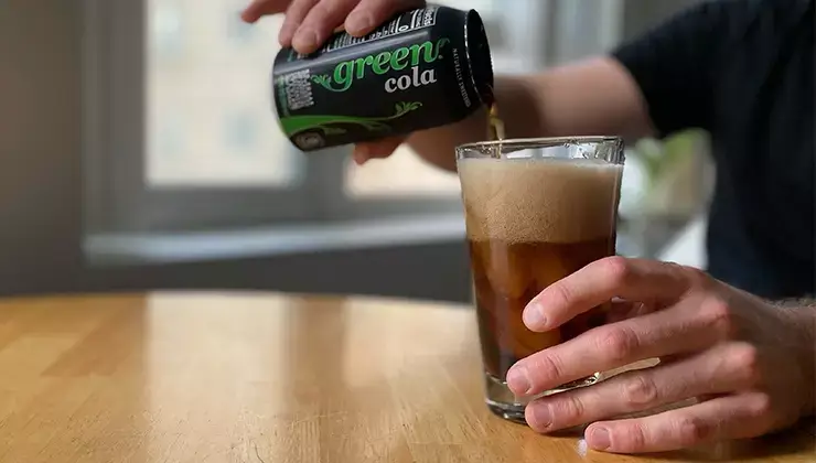 Man pouring Green Cola into a glass