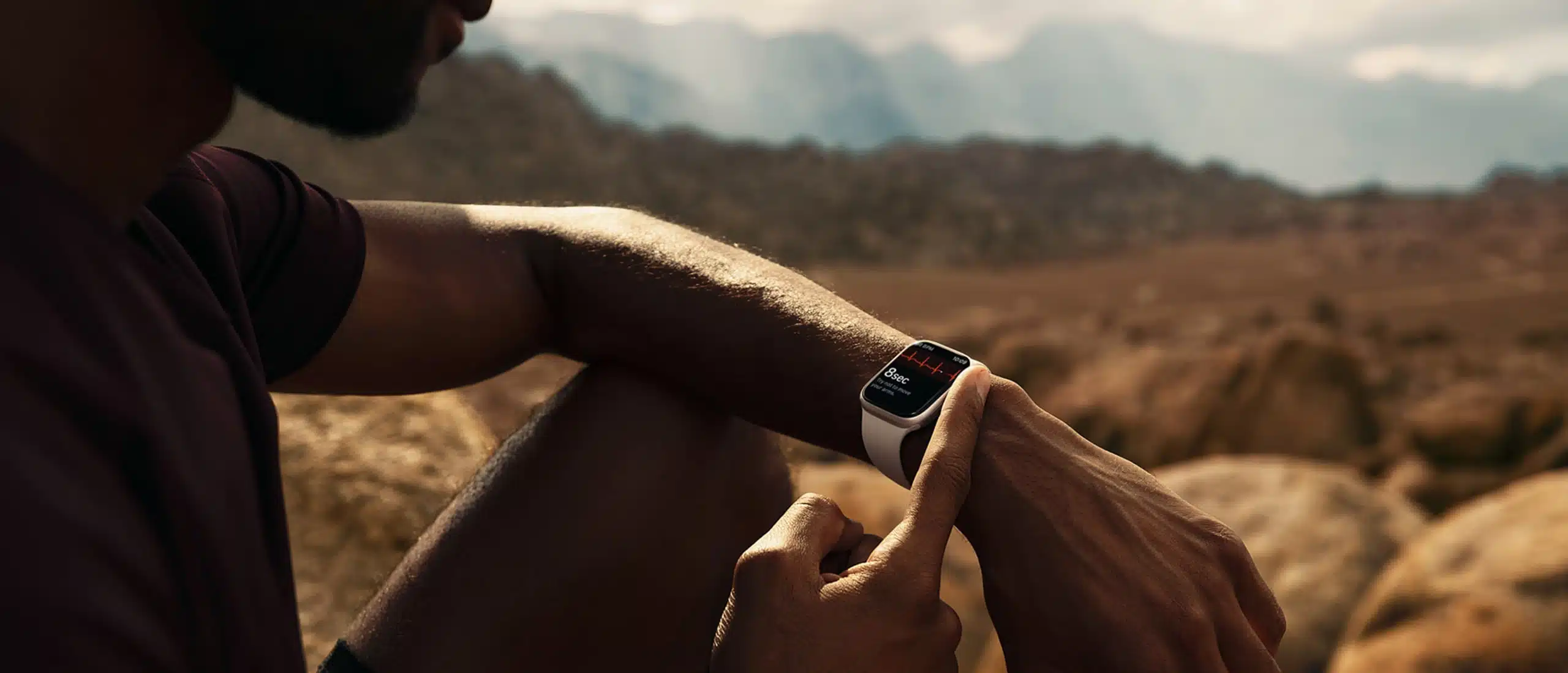 man looking at apple watch series 7 in the desert