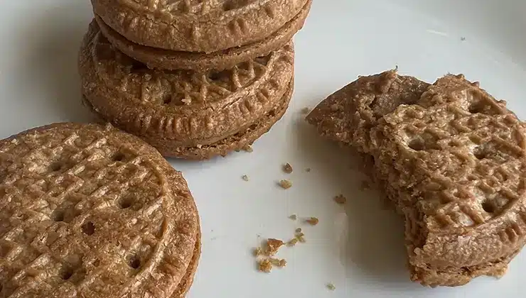 Simple Mills Peanut Butter Cookies stacked with one that has a bite out of it so you can see the creamy peanut butter center