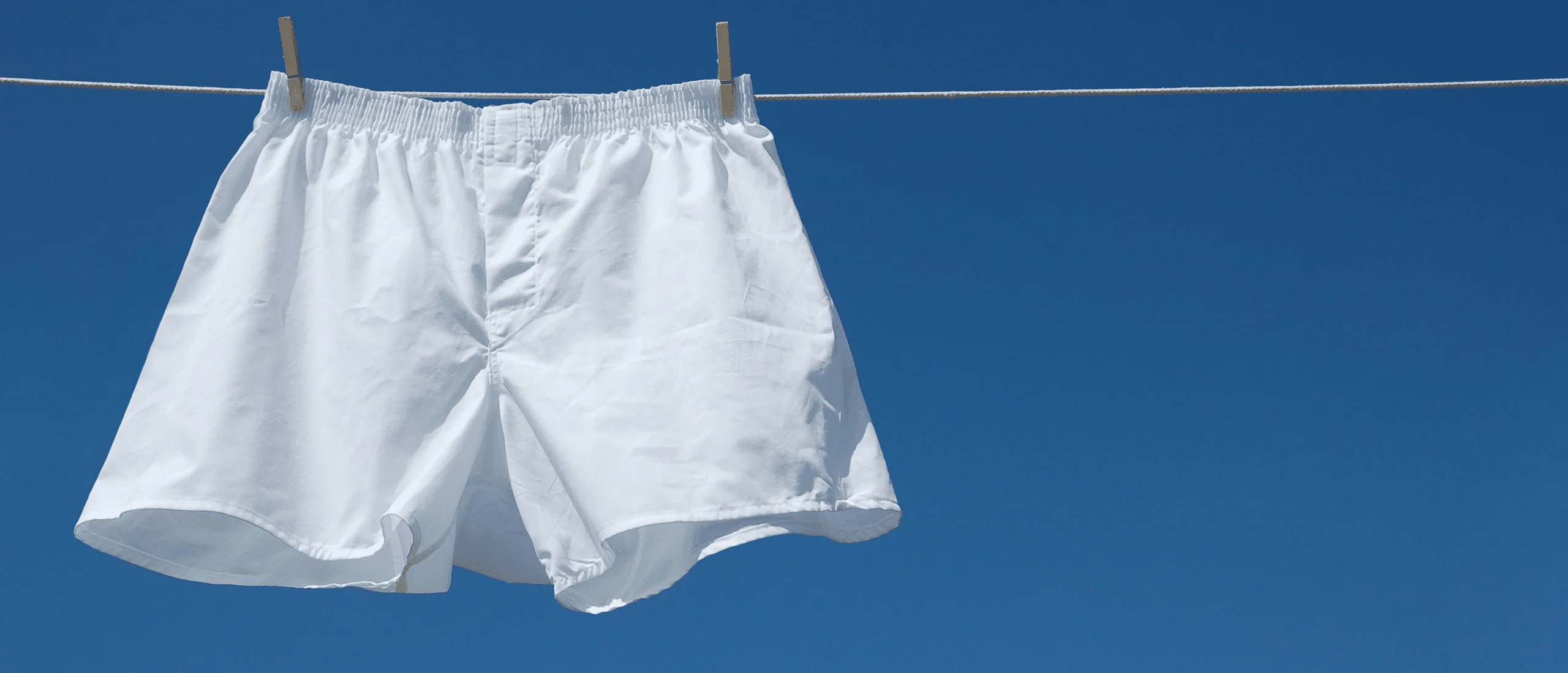 mens white boxers hanging from clothes line
