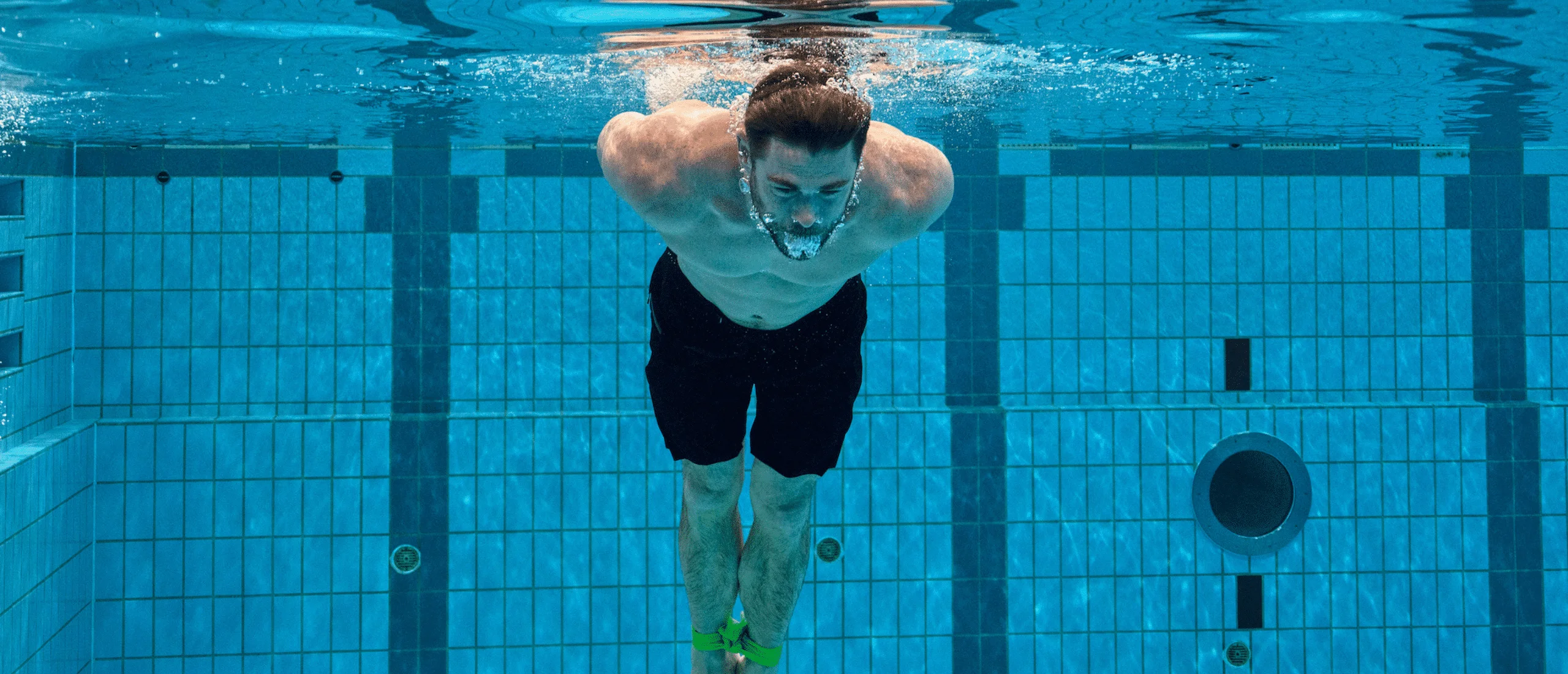 Chris Hemsworth swimming in a pool