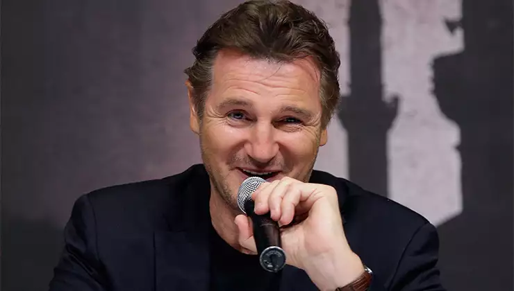 Liam Neeson talking on stage