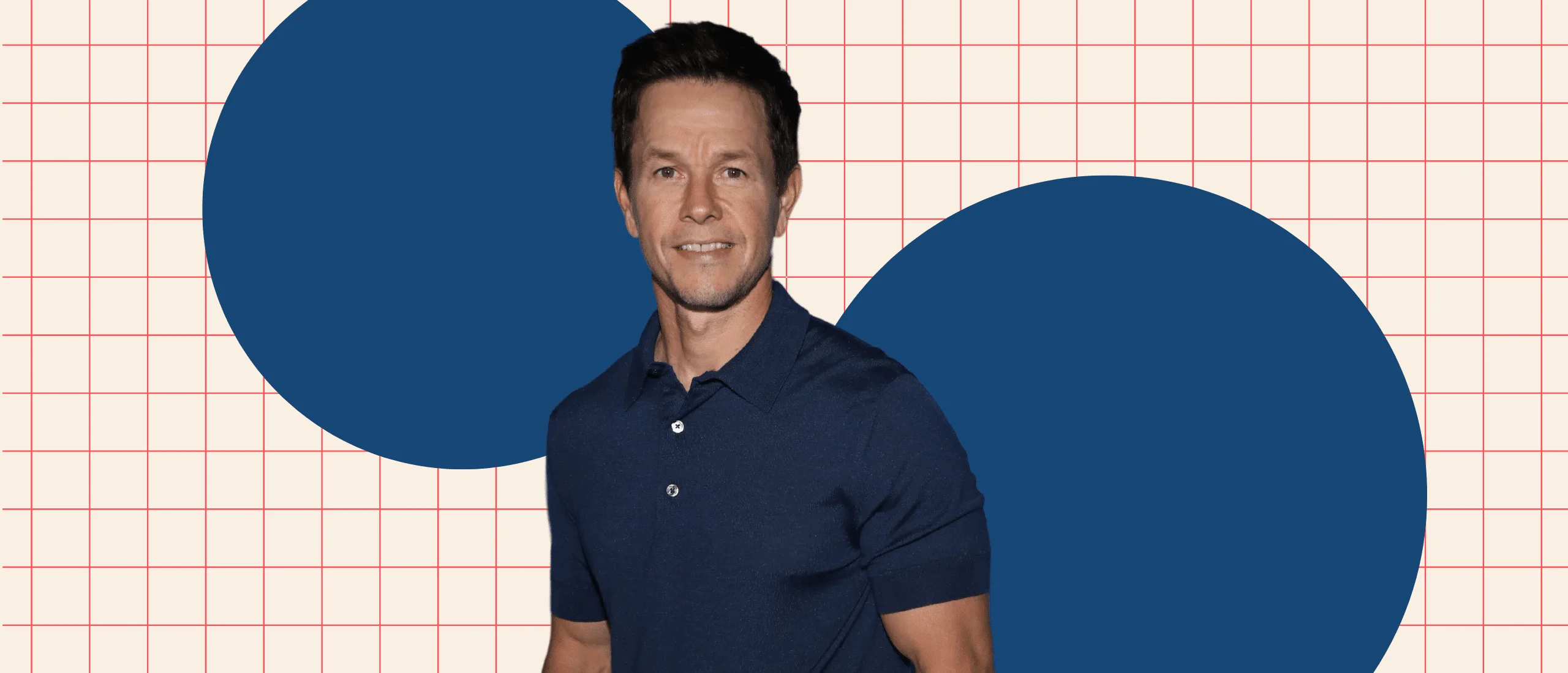 Mark Wahlberg standing in front of beige grid with two large blue circles