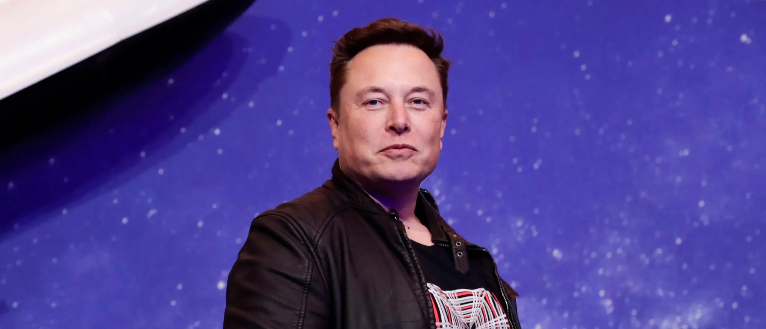 elon musk in a leather jacket looking at the camera for a photo