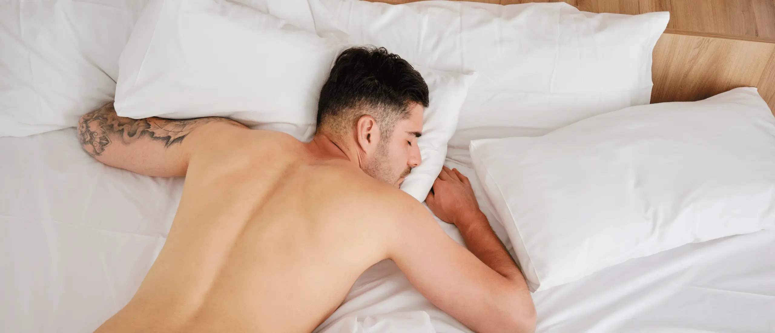 man sleeping in bed naked