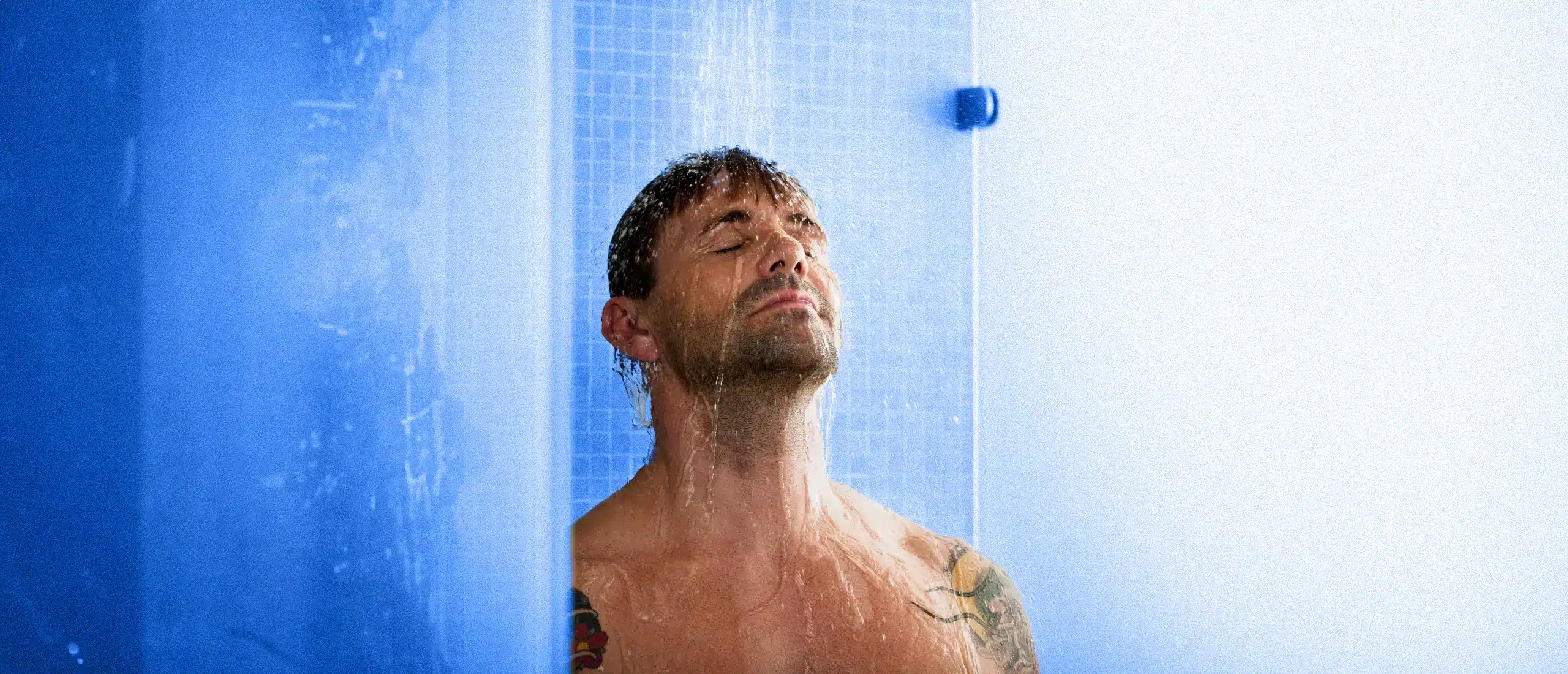 Man looking extremely relaxed for how cold his shower is.