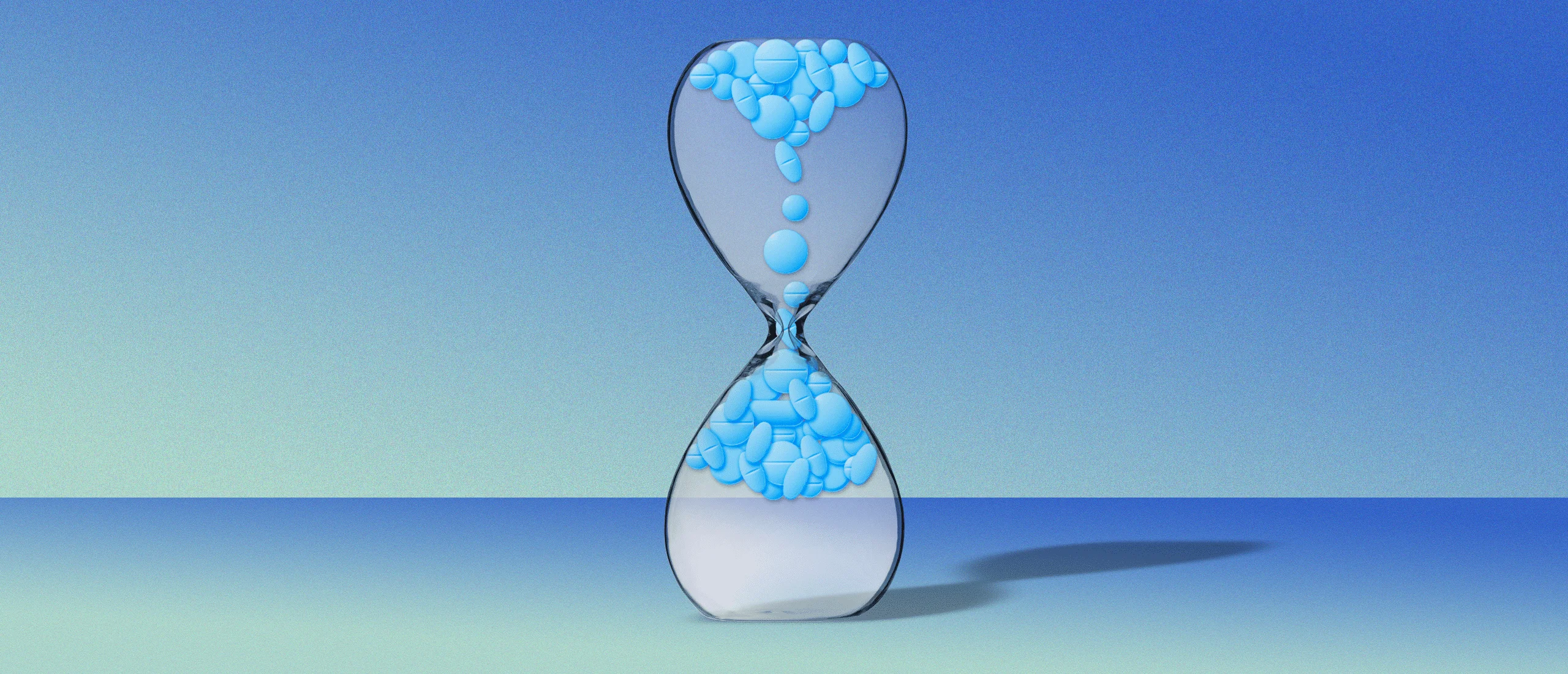 Pills falling upwards in an hourglass on blue background