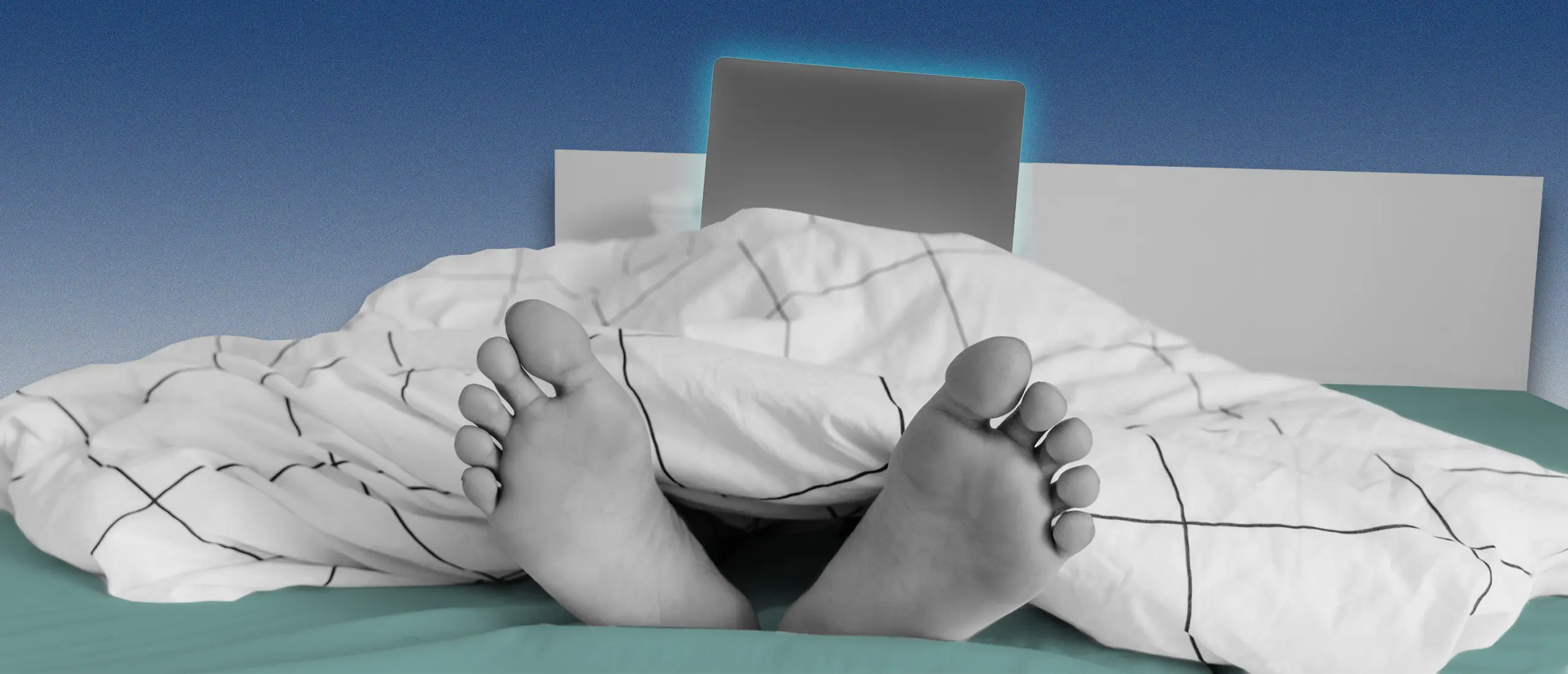 A man lying in bed with laptop
