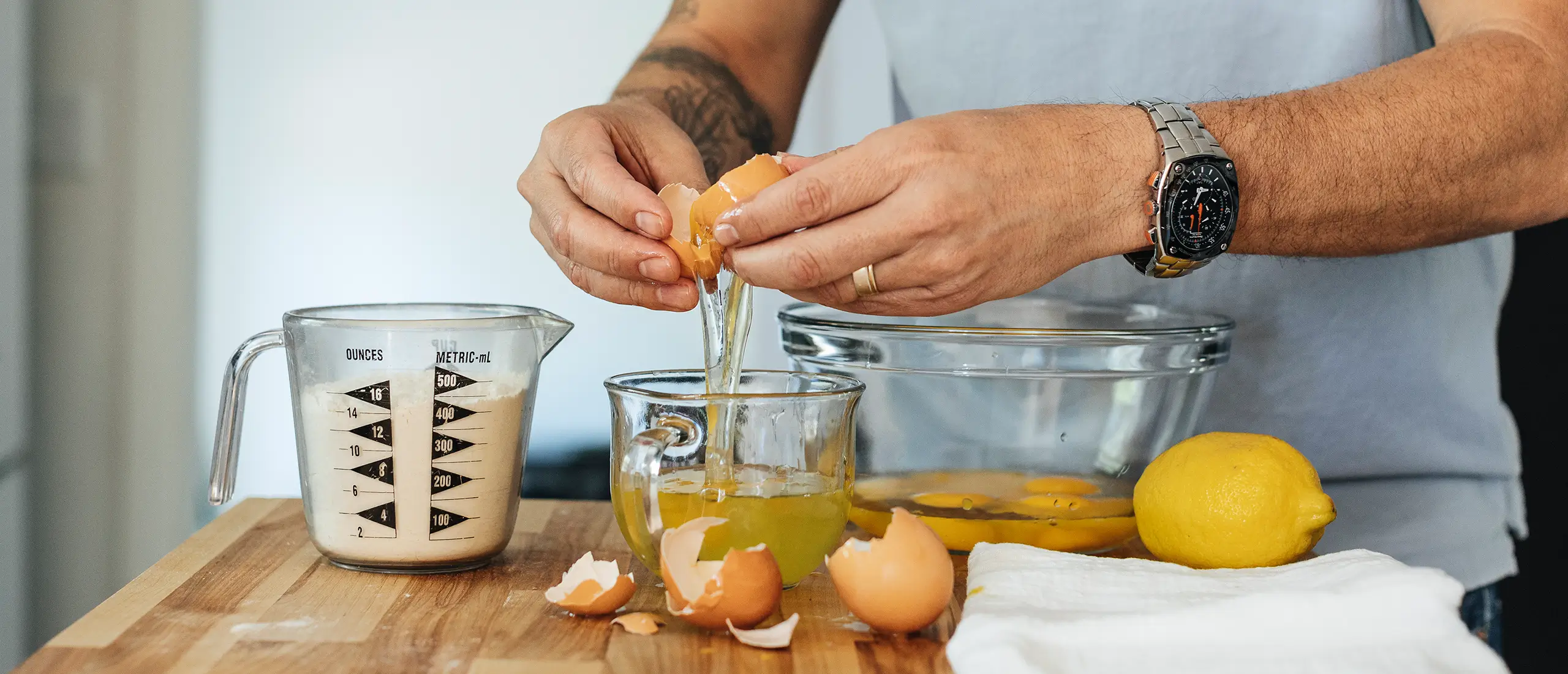 a man separating egg whites from egg yolks