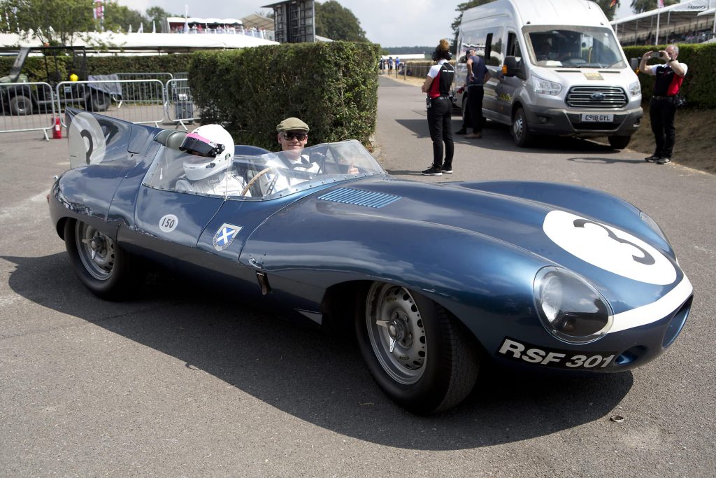 CHICHESTER, ENGLAND - 14th July: 1956 Jaguar D-type 'long nose' entered by The Louwman Museum and driven by Evert Louwman and Quirina Louwman at Goodwood on July 14th, 2018 in Chichester, England.