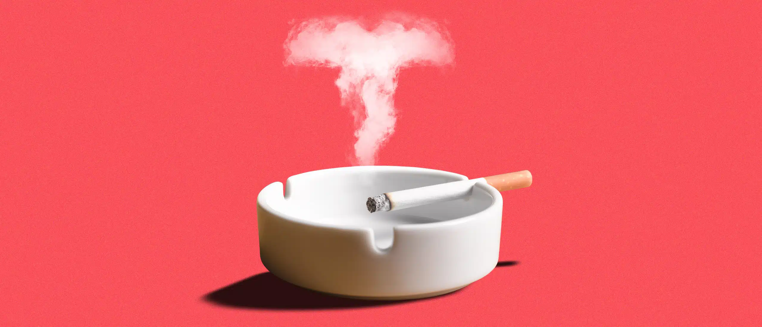 A cigarette in an ash tray. The smoke is in the shape of a T