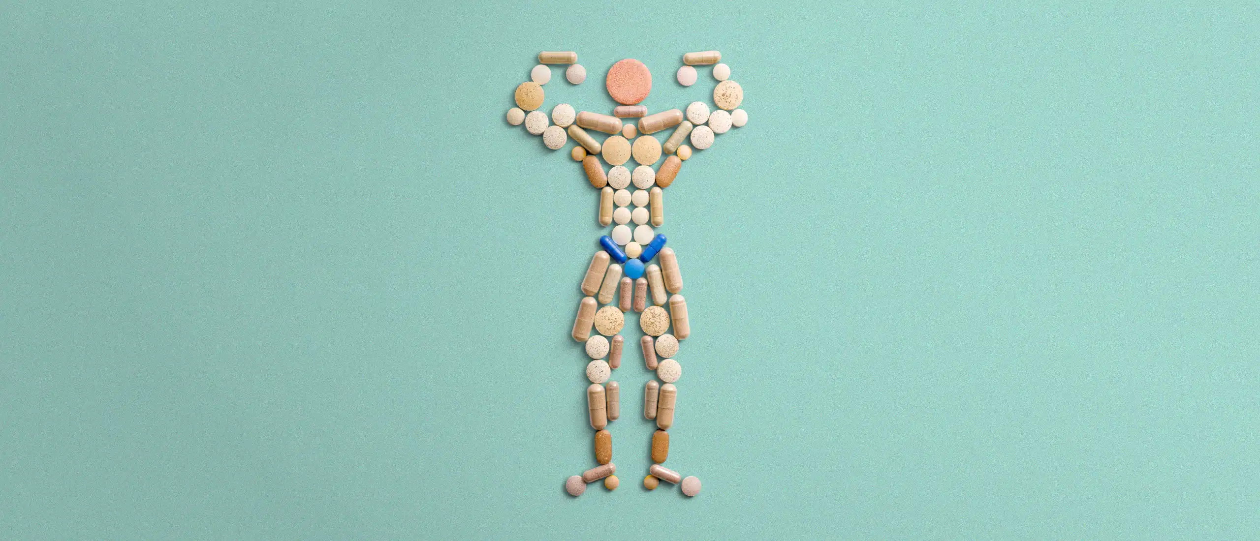 Pills arranged into the shape of a man flexing