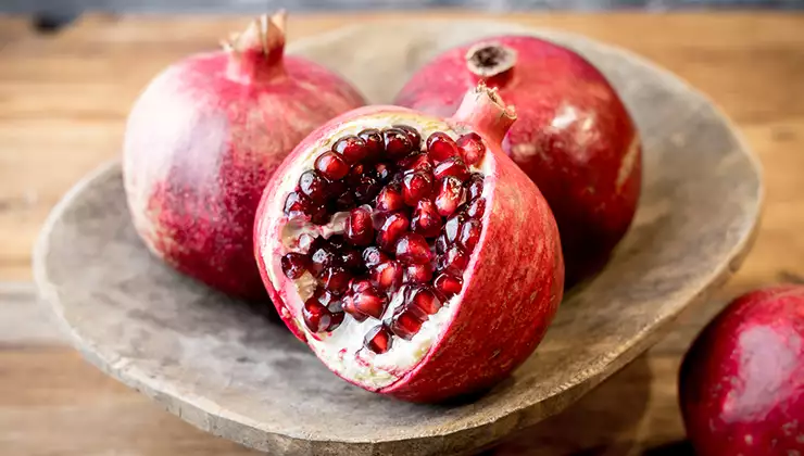 Three pomegranates on a plate